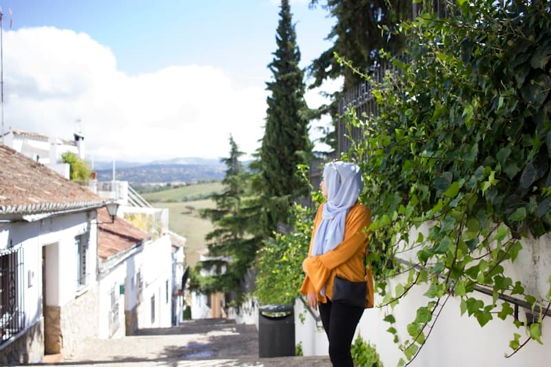 Woman in hijab traveling abroad, representing passport and travel documentation